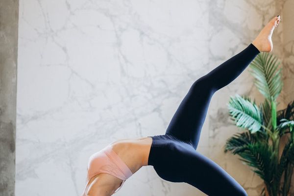 Person moving gracefully from one yoga pose to another.