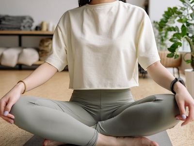 Person sitting in a meditative pose with eyes closed.